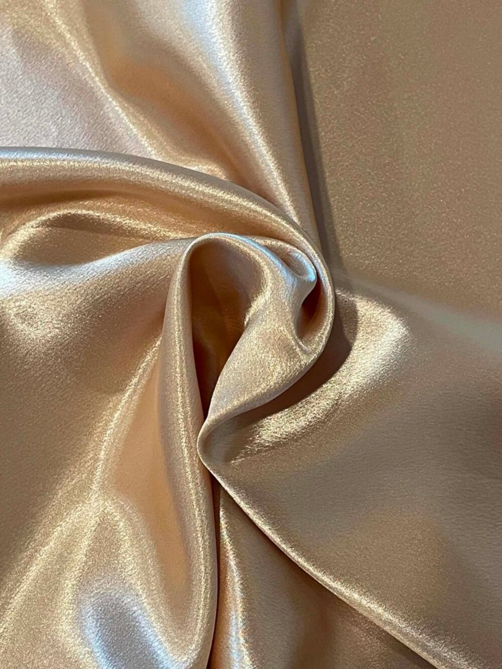Gold colored crepe backed satin fabric.  Sold by the yard.